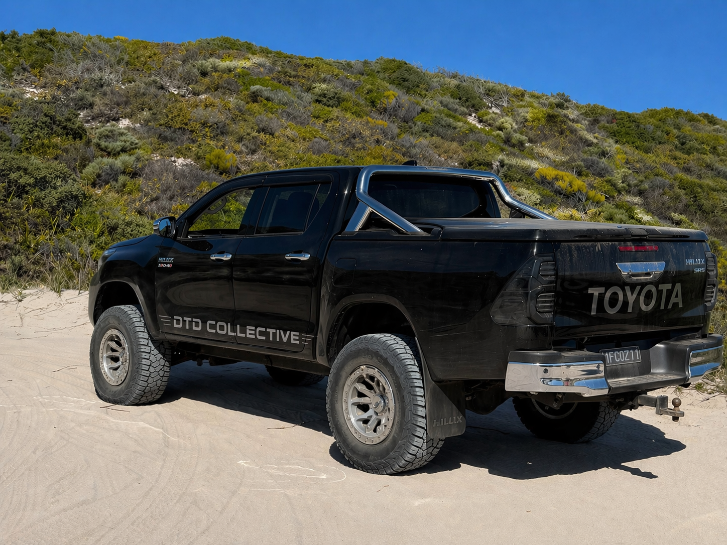 DTD Collective black Hilux on the dunes